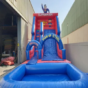 Children having a blast on a vibrant inflatable water slide featuring an exciting Superman theme, with iconic red and blue colors, Superman's emblem, and thrilling graphics of the Man of Steel in action.