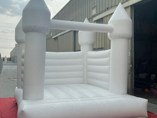 White Bouncy Castle - A whimsical inflatable centerpiece for joyous celebrations.
